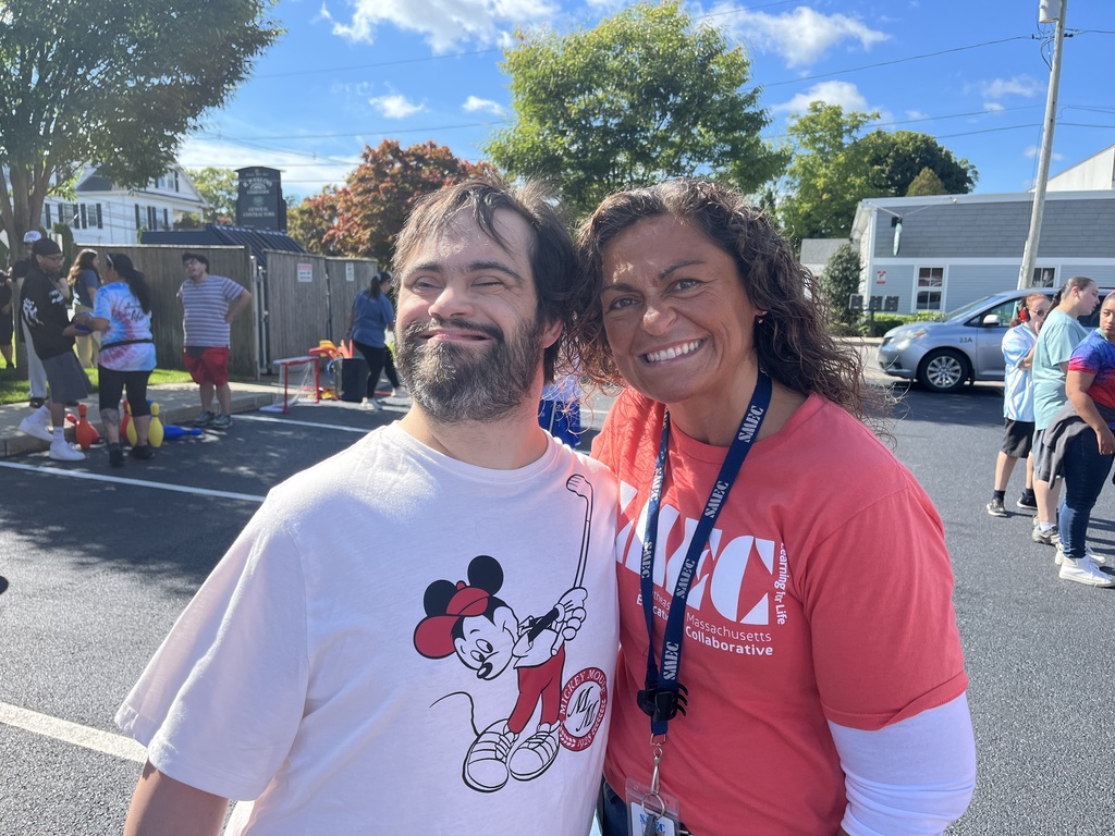 Man and woman smiling together in a parking lot 