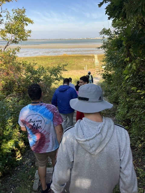 A group of students walking down to the beach