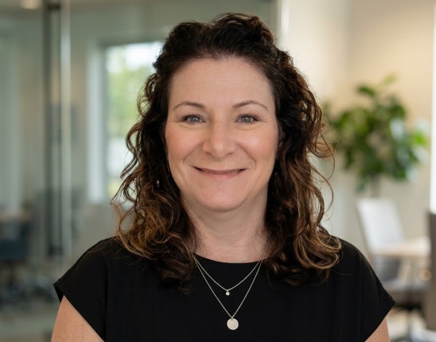 Picture of Kimberly Moreton standing in front of an office set up