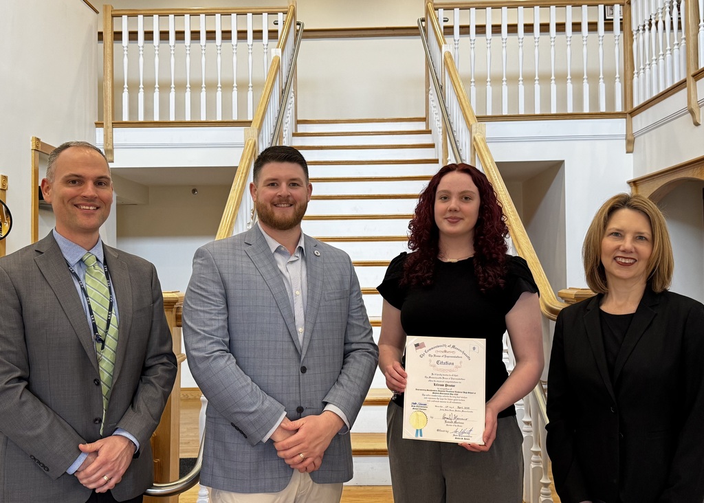 Student accepting an official citation from a state representative. Left to right: Principal, State Rep, Student, Superintdenet