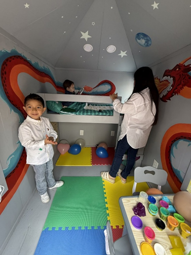 Liam inside playhouse
