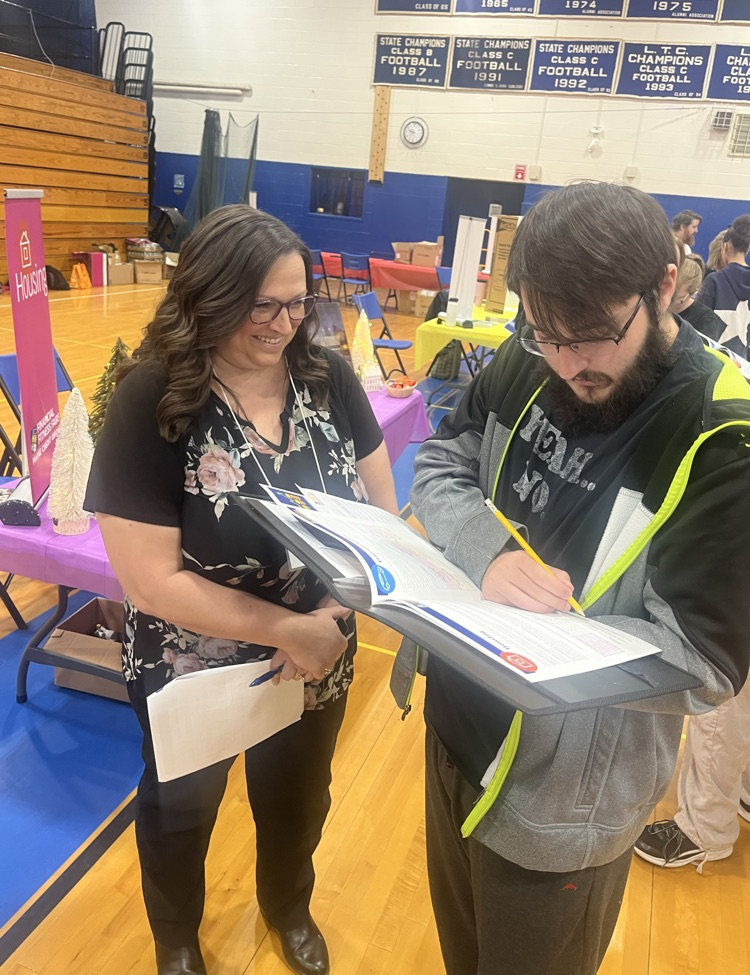 Senior, Chris Daniels, learning about housing options with KFCU representative