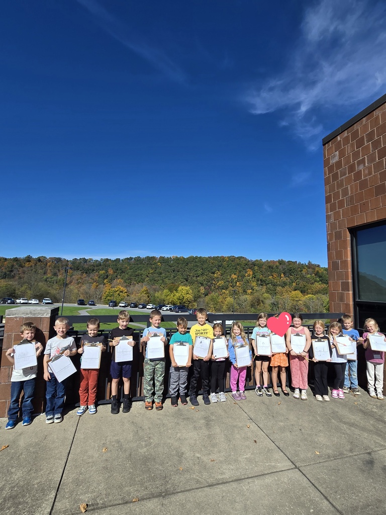 photo of students practicing their writing outdoors