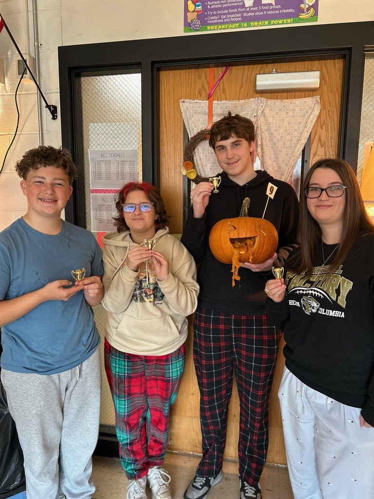 photo of students with carved pumpkin