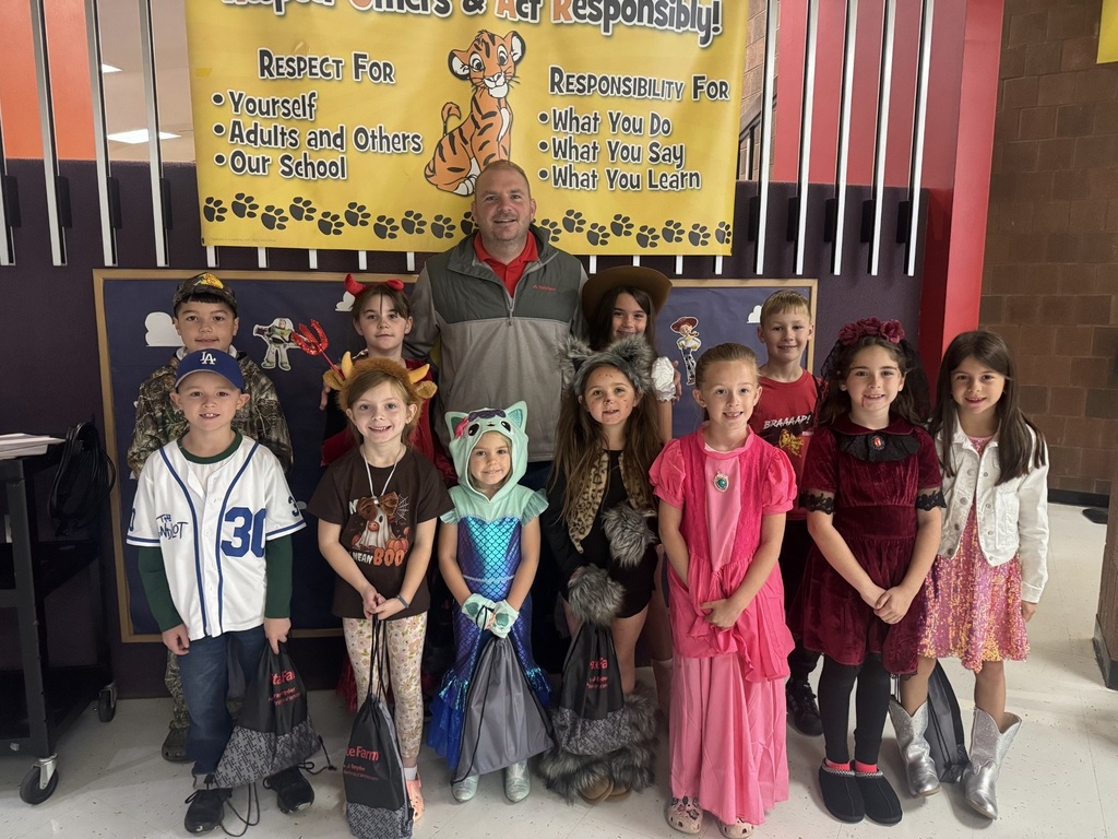 students of the month posing in halloween costumes