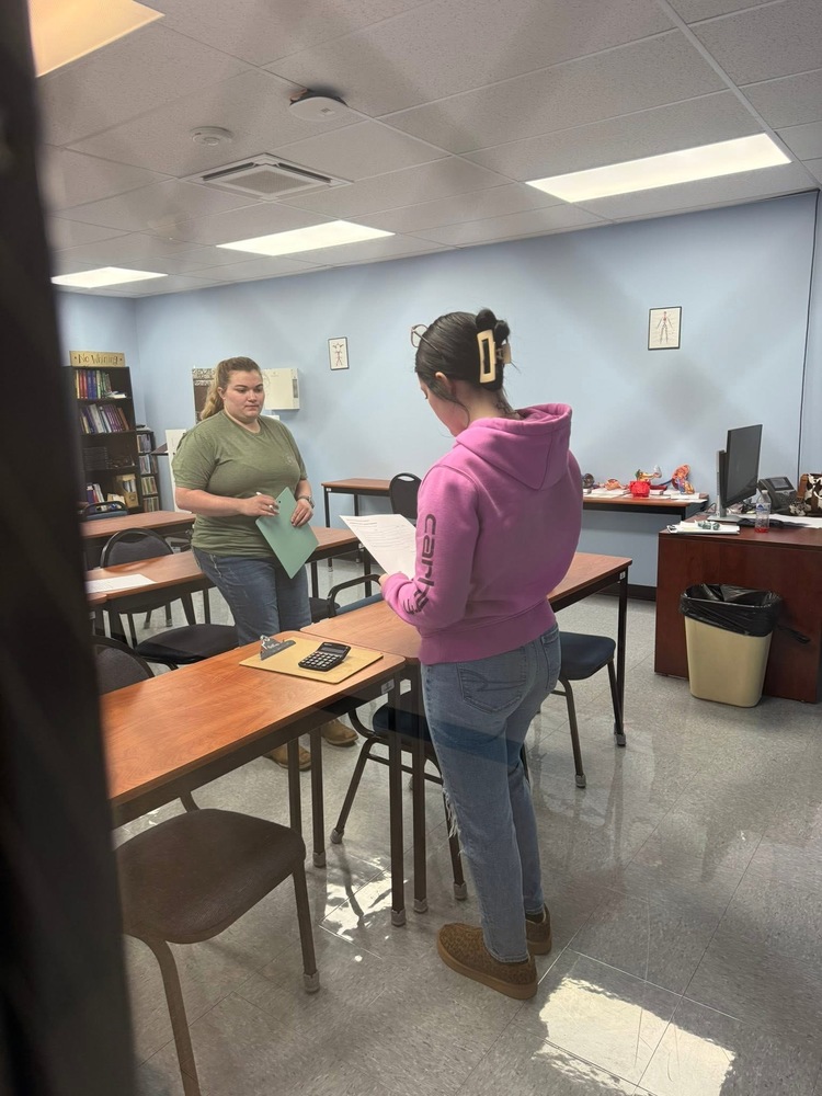 Skyler Allen reading over instructions to give oral meds to a dog.