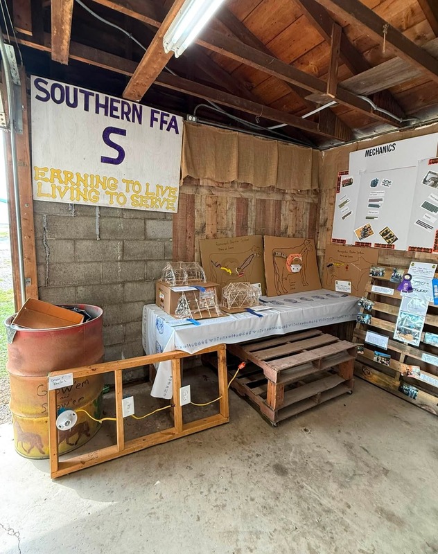 Pictures of are officer pallets displaying events throughout the year along side classroom projects involving animal science, and green house structures.
