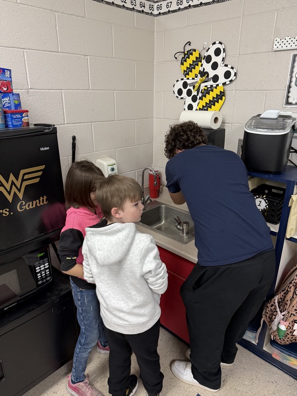 Pictured: Hunter Jarrell helping a few students with soap and water and how to properly wash their hands while singing their ABC’s.