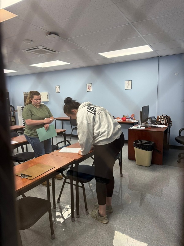 Emma Owens reading over instructions for giving oral meds to a dog. 
