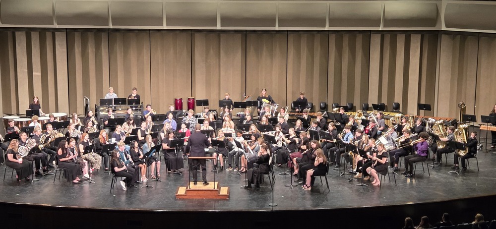 A large band plays on a stage