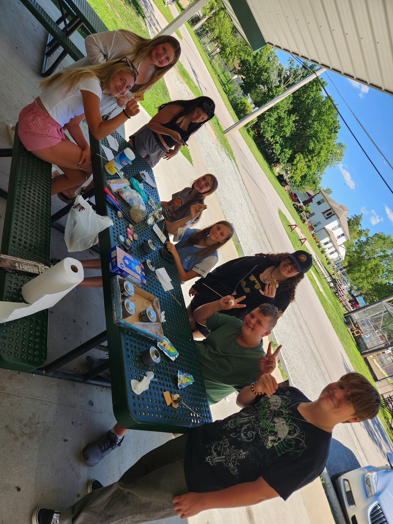 Students enjoying making their own s'mores outside at the park.