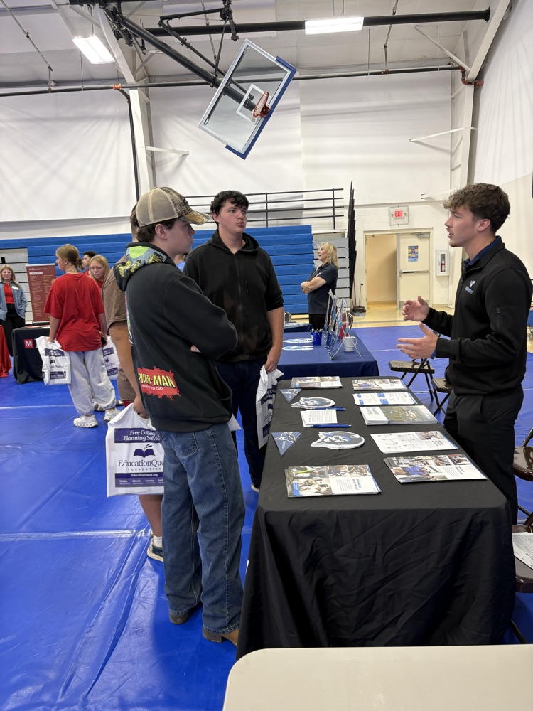students talking with college rep