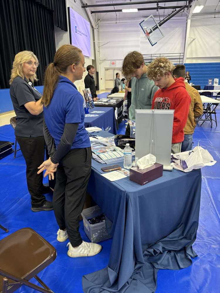 students visiting with college rep
