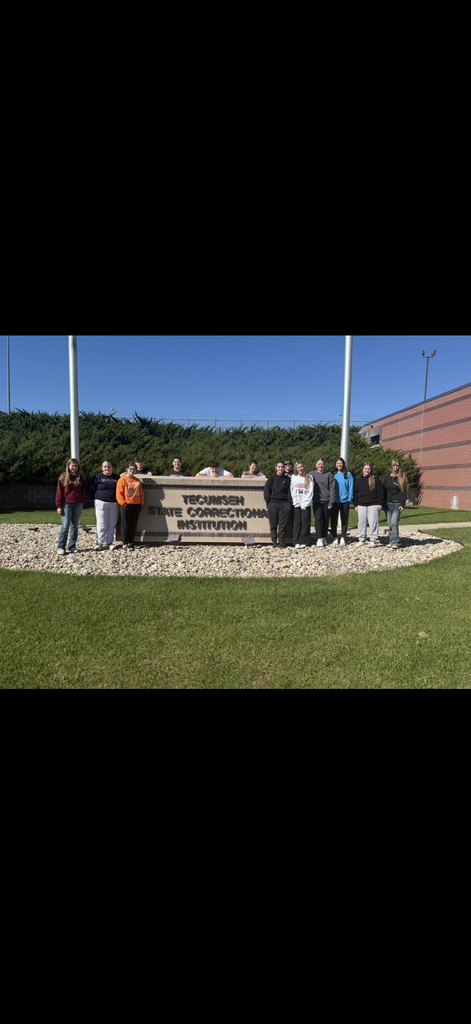 Students posing for a picture in front of the Tecumseh State Correctional Institution