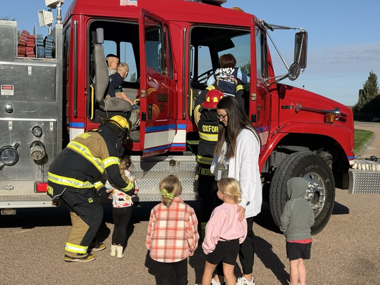 students riding the fire truck