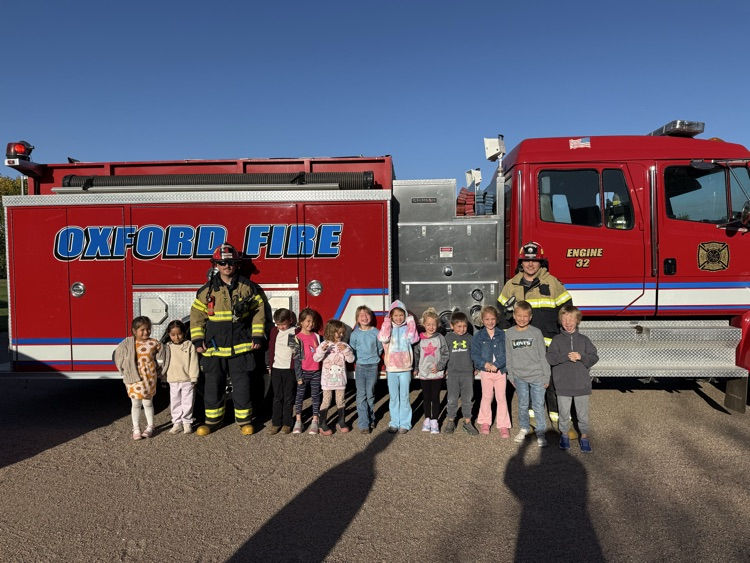students riding the fire truck