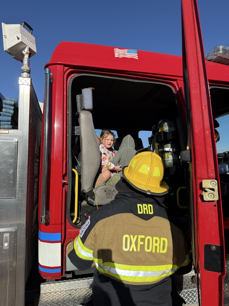 students riding the fire truck