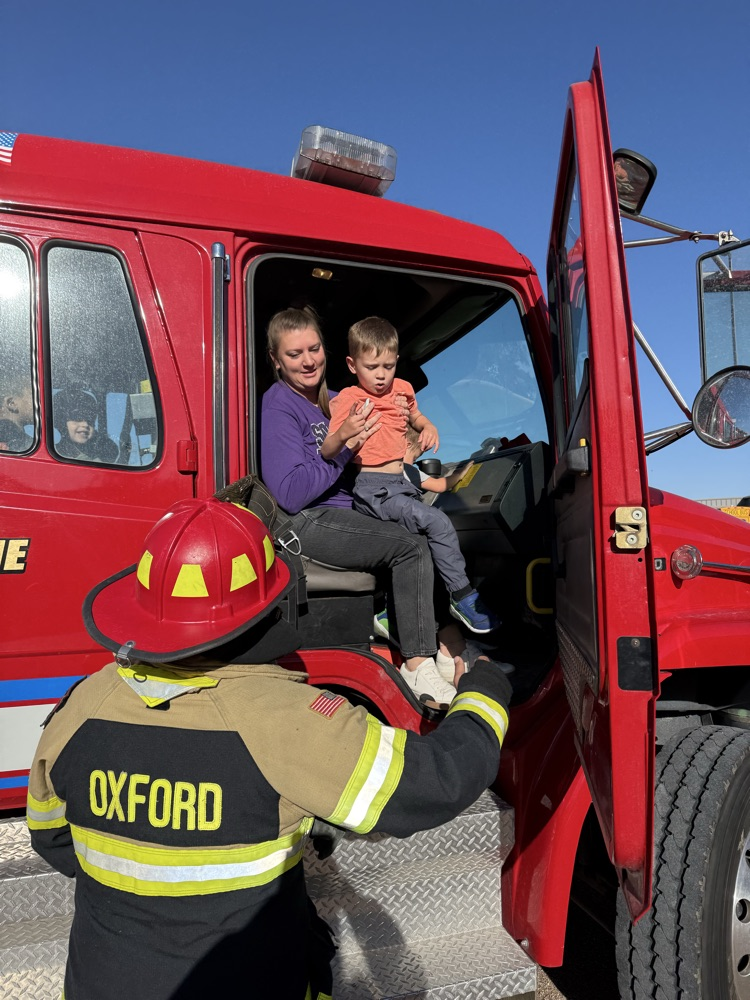 students riding the fire truck