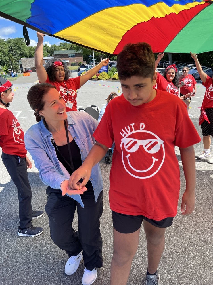 teacher assists student in outdoor activity