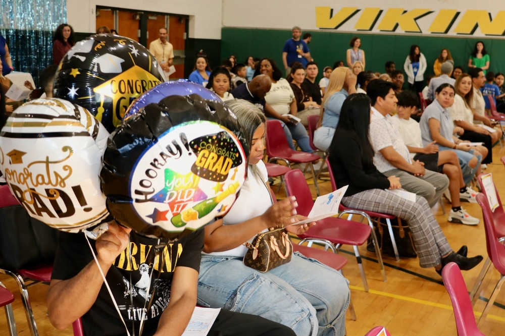 balloons and a packed gym at graduation
