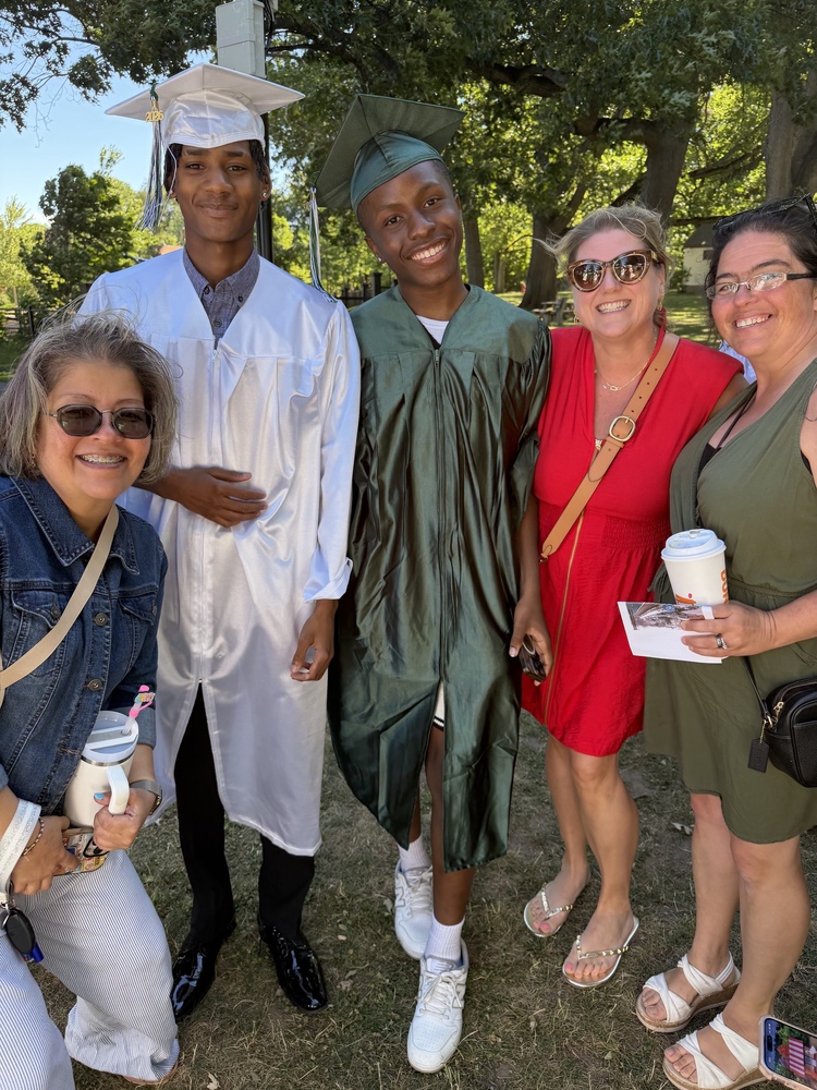 graduates and educators celebrate outside