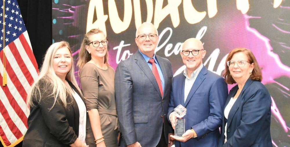 5 people standing in front of a screen