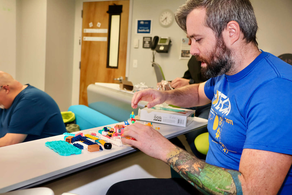 educator building LEGO as part of STEAM playdate
