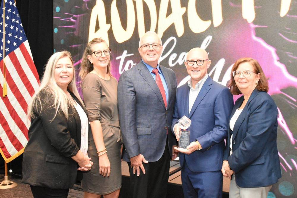 5 people standing in front of a screen