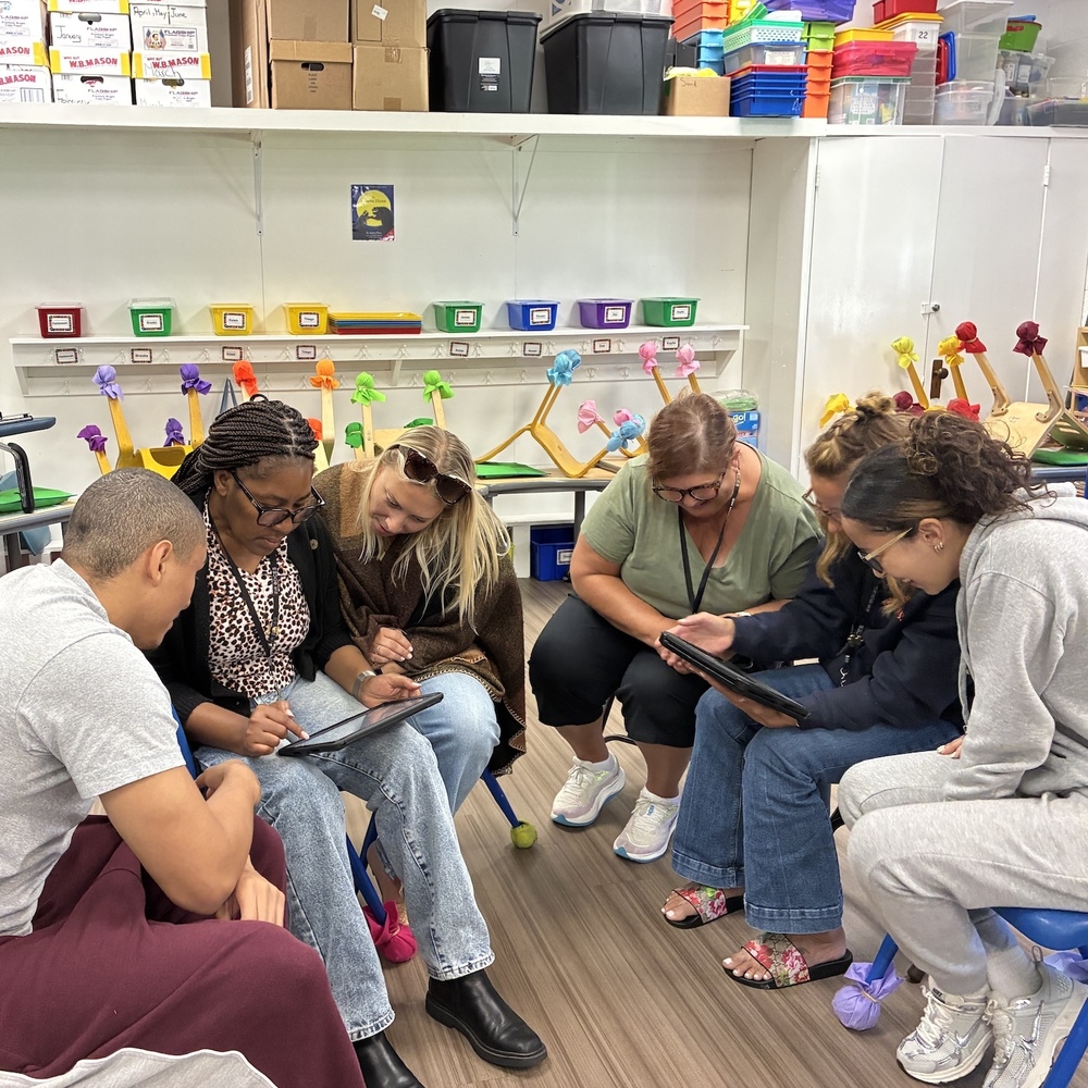 teachers in semi-circle work on team project