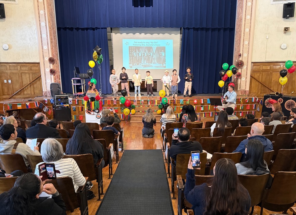 students performing for Black History celebration before audience of family and educators