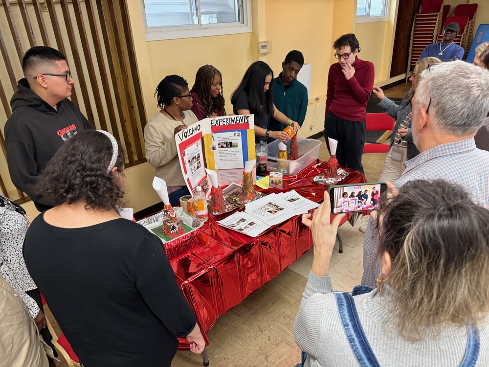 students demonstrate science experiments for parents at fair