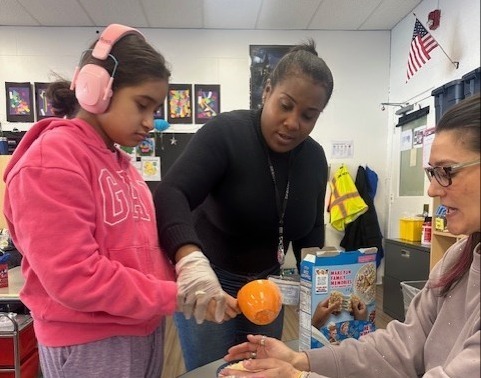 teacher assists students in a classroom