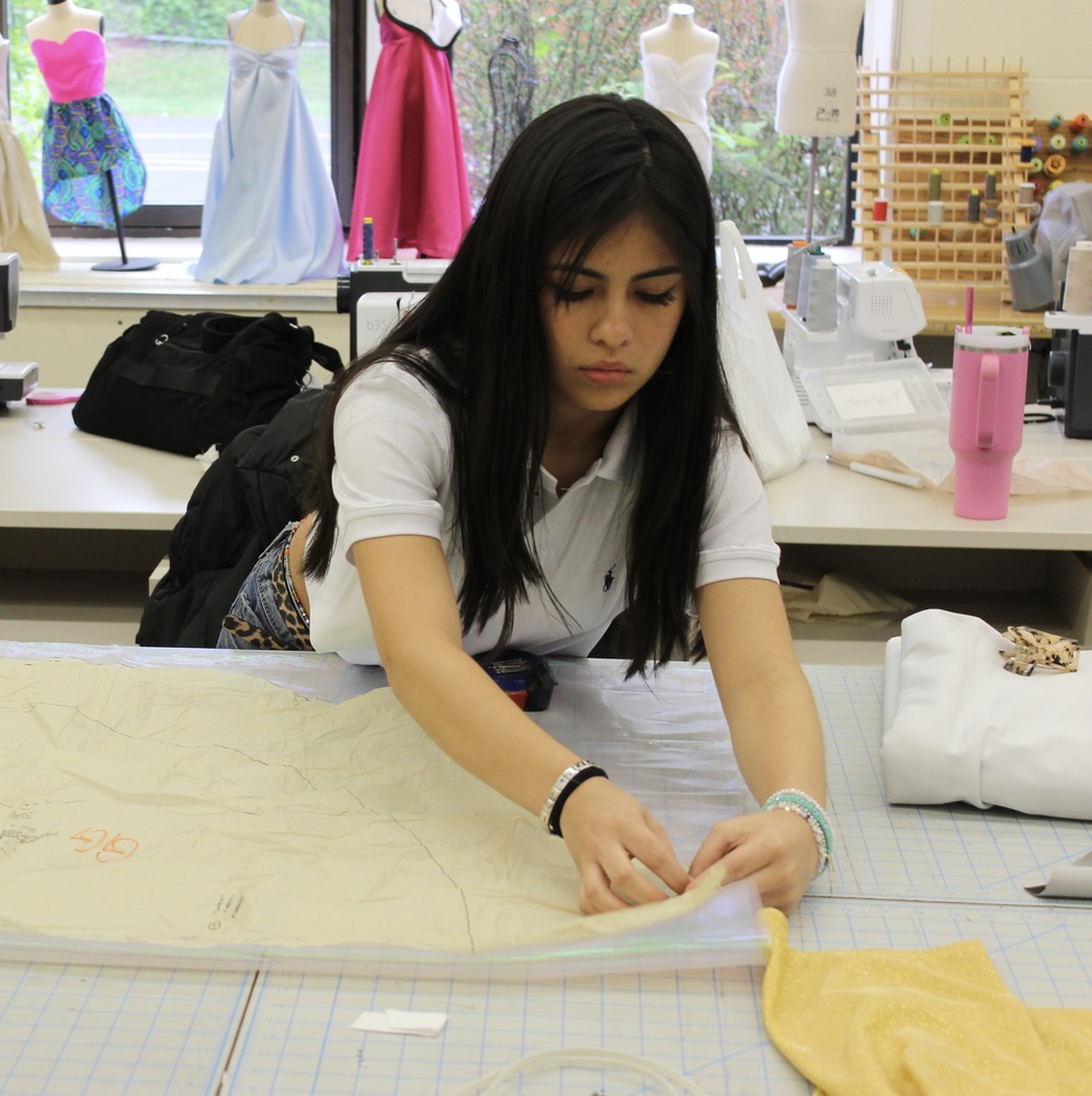 A Fashion Design & Merchandising student prepares for the upcoming fashion show.