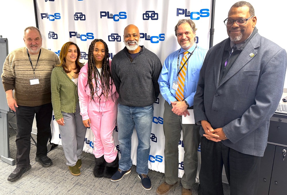 District officials and family members stand with honored employee