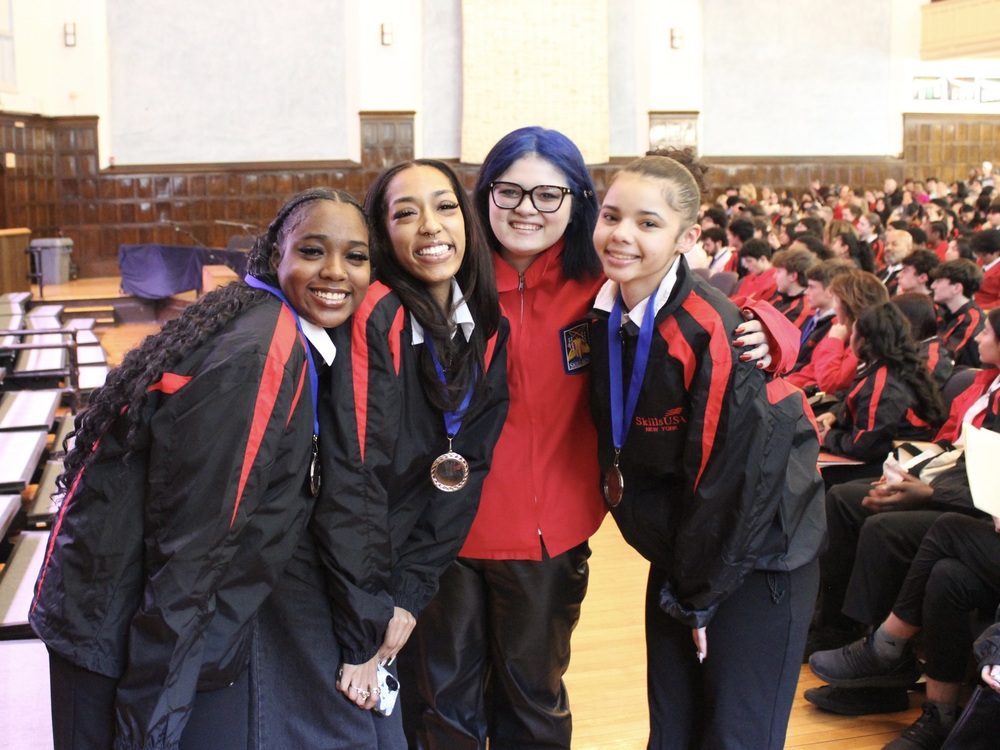 four students celebrate medals at SkillsUSA regional competition