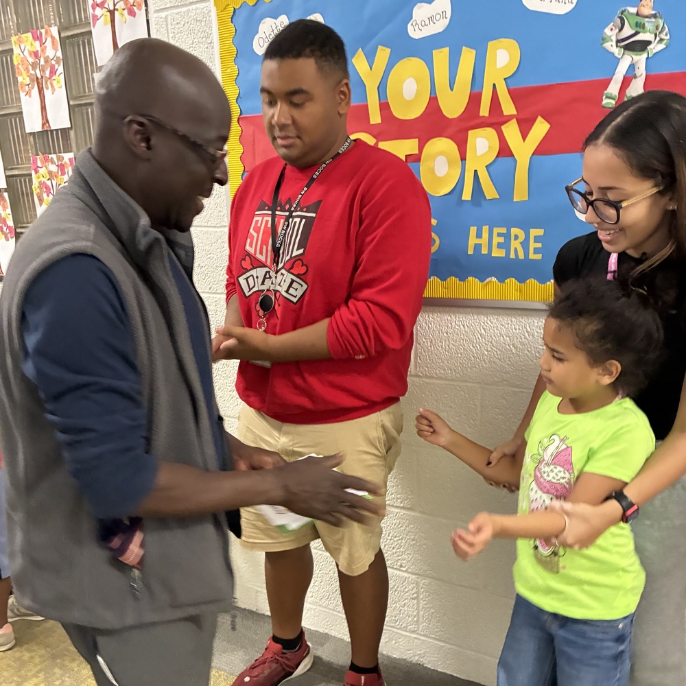custodian accepts gift from student as educators watch