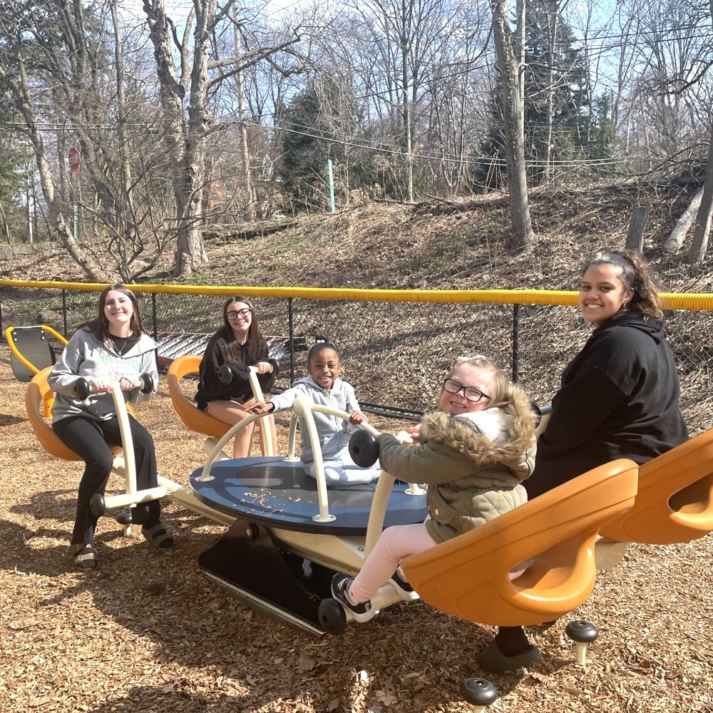 students of different ages on playground equipment