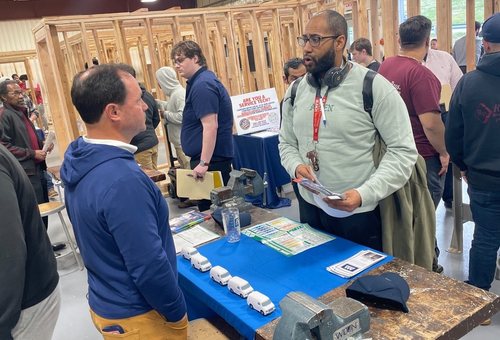 two men talk in warehouse about job opportunities
