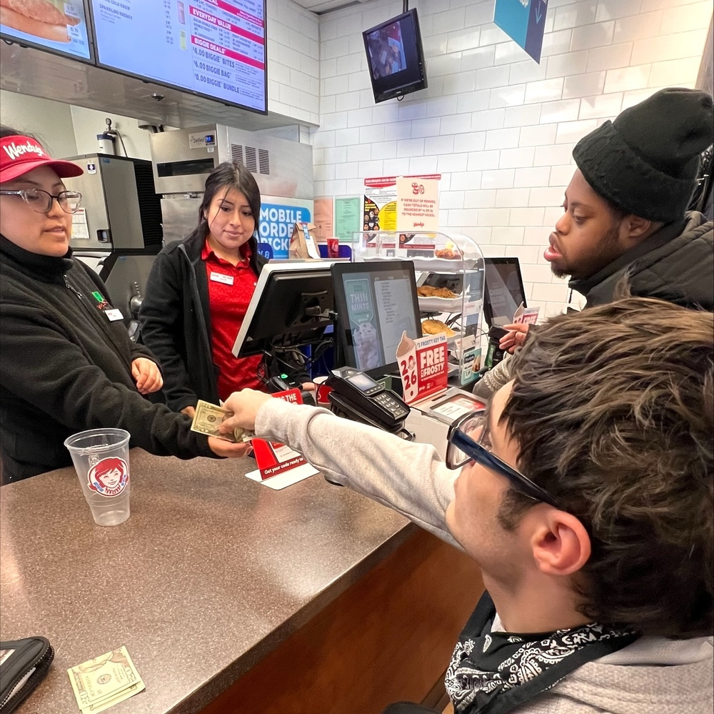students pay for lunch at Wendy's during lunchtime life skills trip