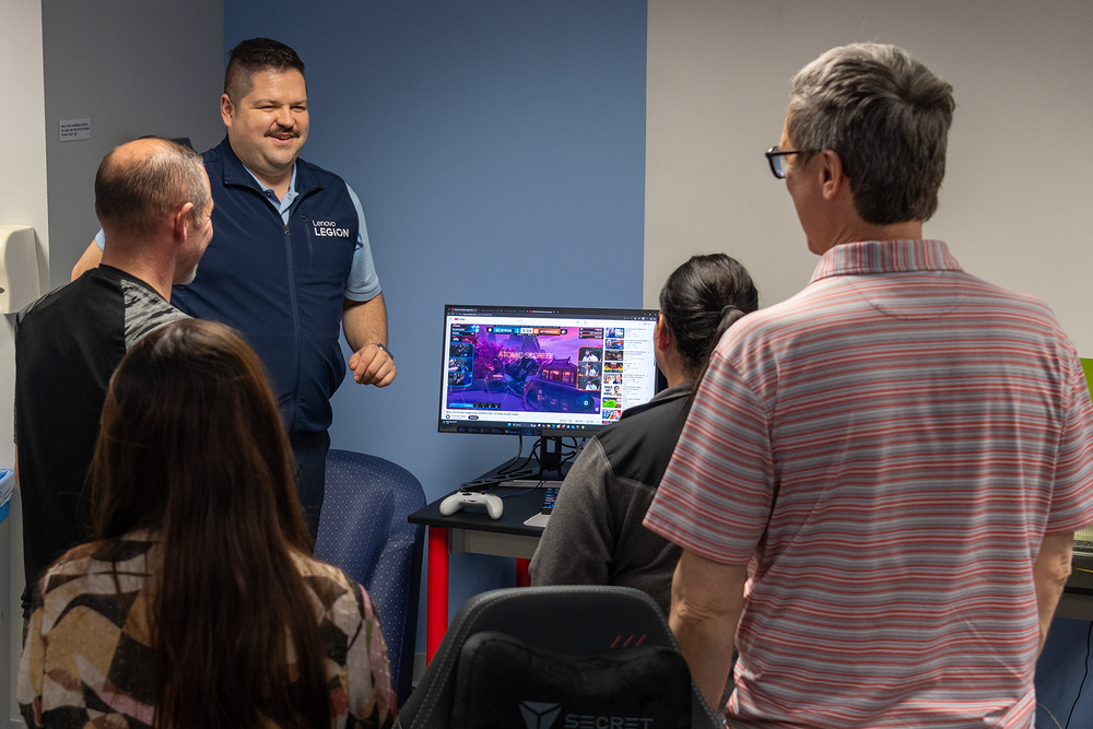 Keynote leads a session on esports by a gaming setup
