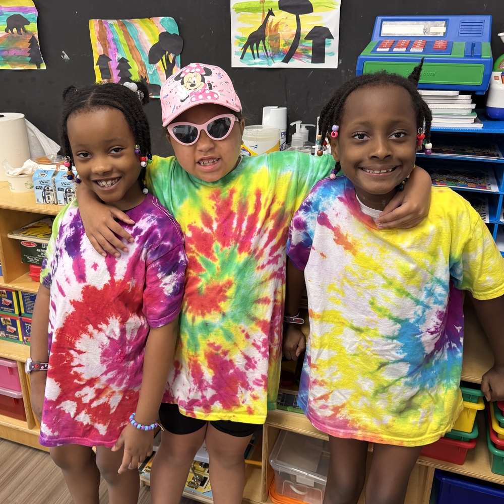 three students wore tie-dyed shirts on field day