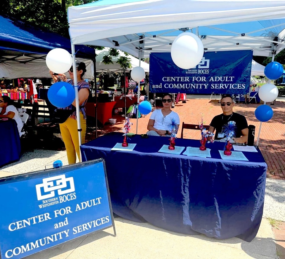 two people at a table at a festival from swboces