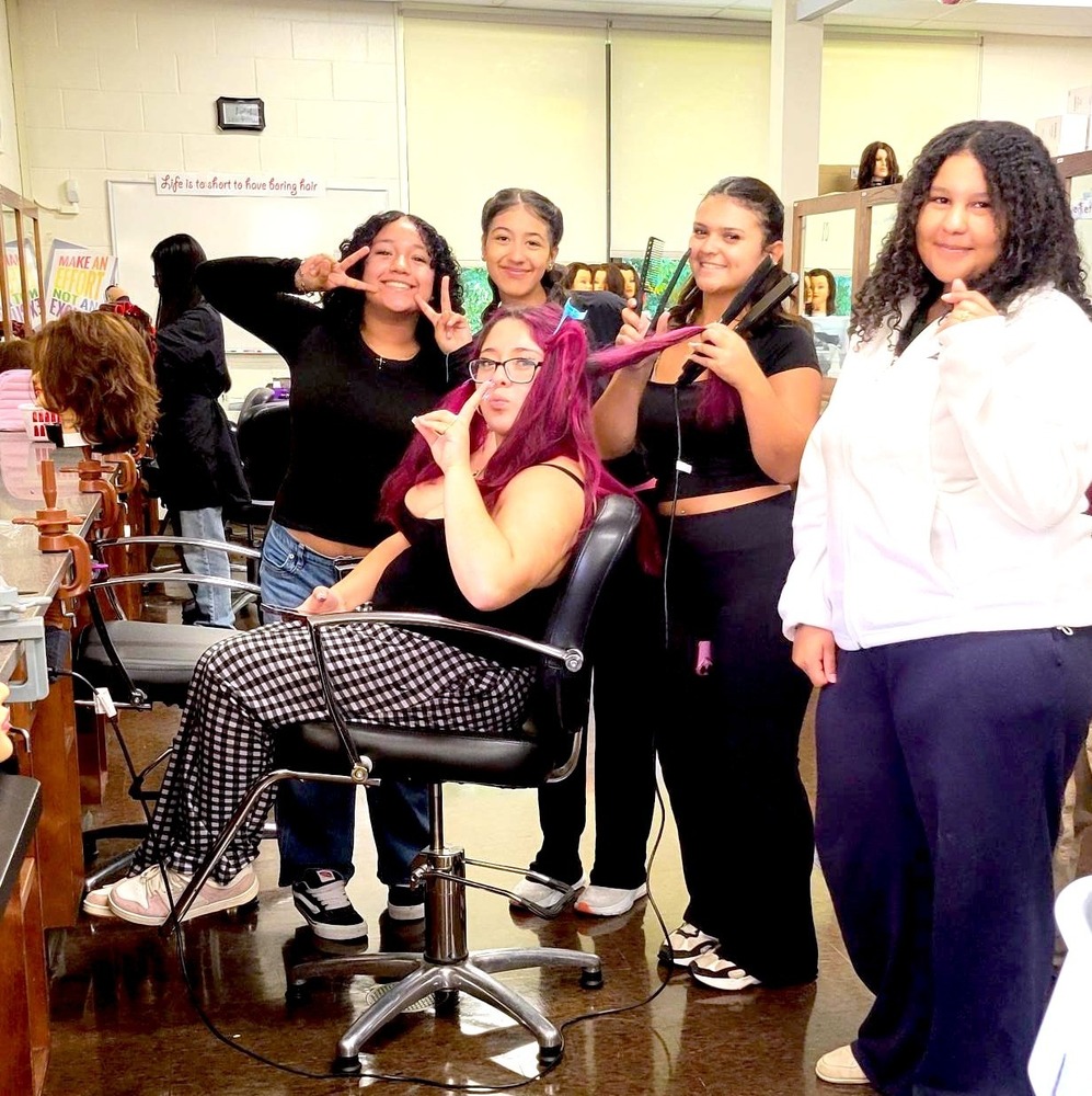 students smile in cosmetology class