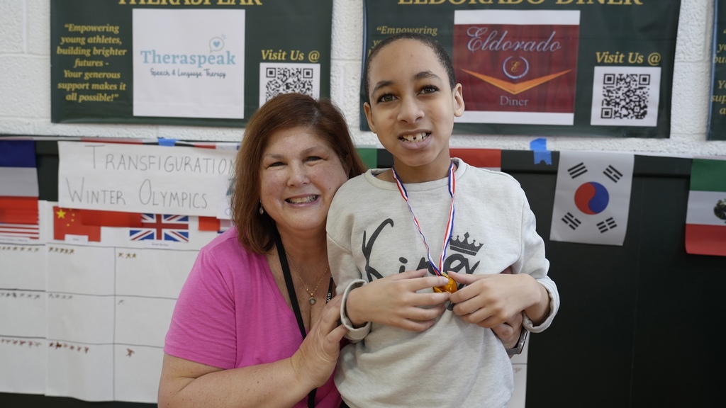 teacher and student show off medal