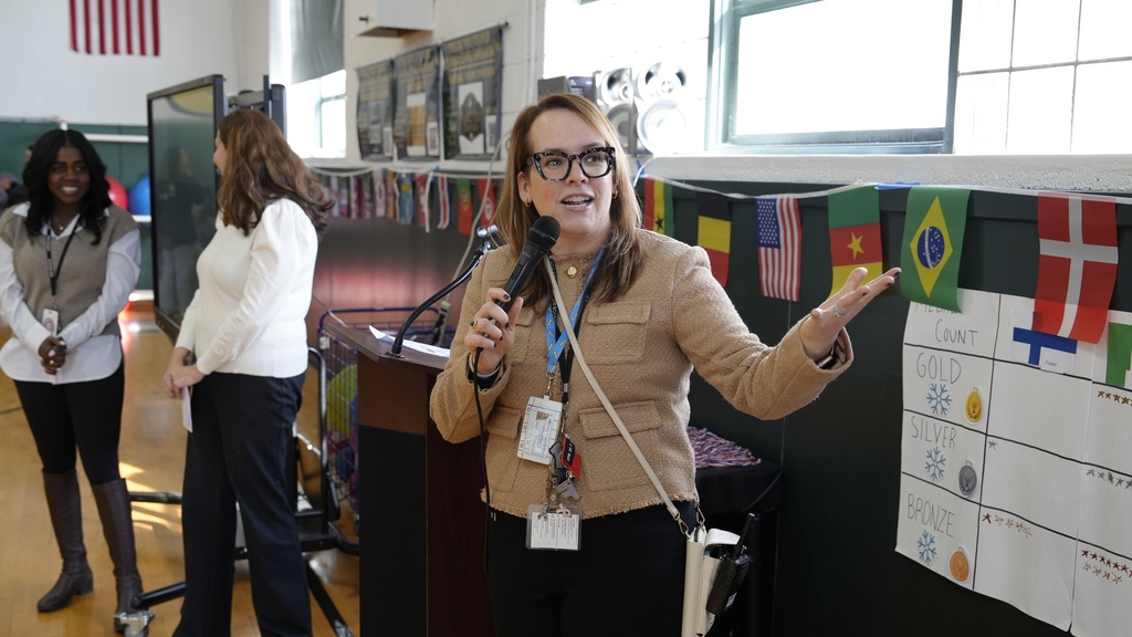 principal speaks as teachers look on