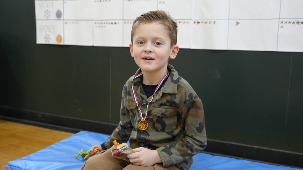 boy on. at shows off medal