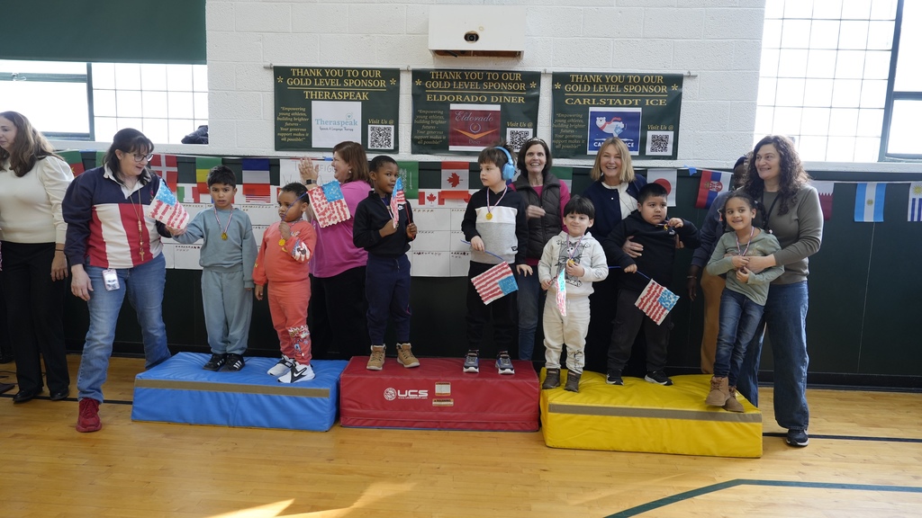 students and teachers line up on Olympic podium