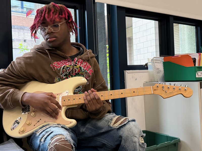 boy plays stratocaster
