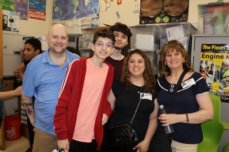 family gathers around proud graduate