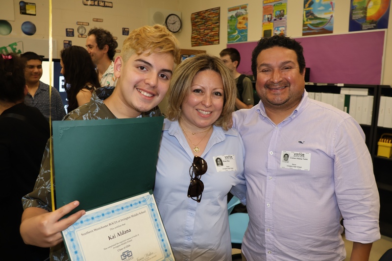 mom and dad alongside graduate
